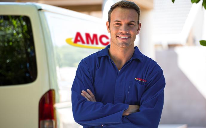 service technician standing outside a home