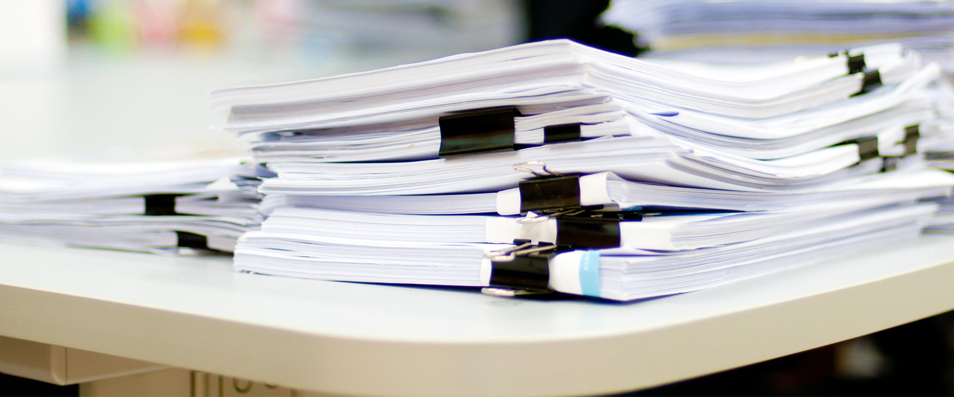 files of resources stacked on a desk