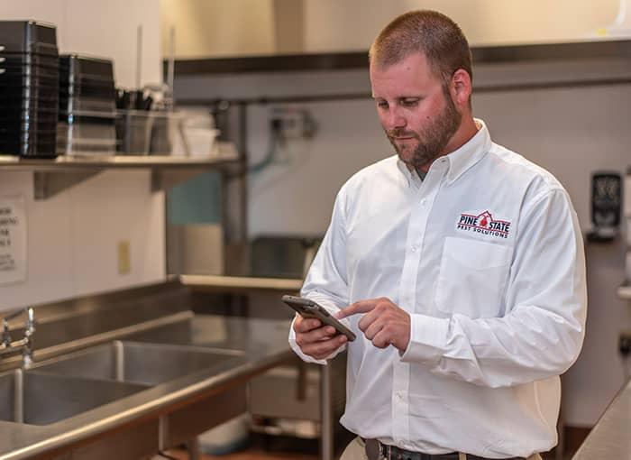 commercial pest control specialist inspecting for mice and rats