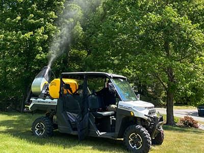 pest control tech spraying for mosquitoes and ticks in auburn maine