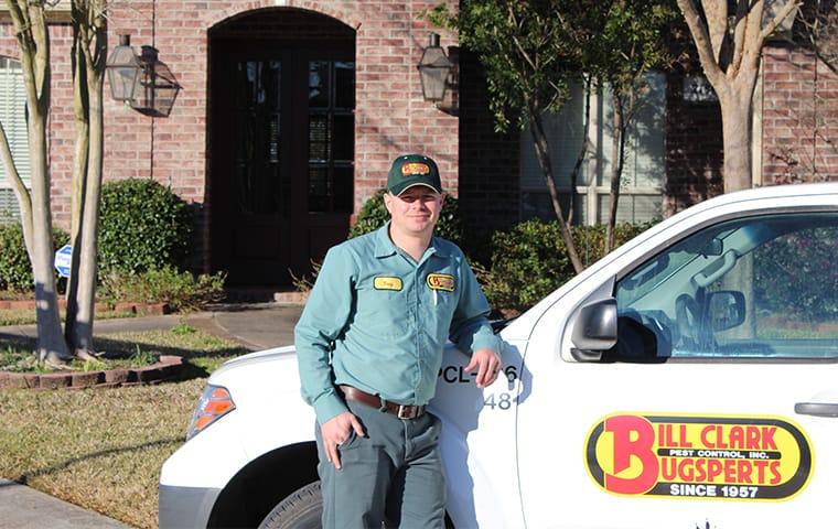 a technician standing outside a company vehicle and home in newton texas