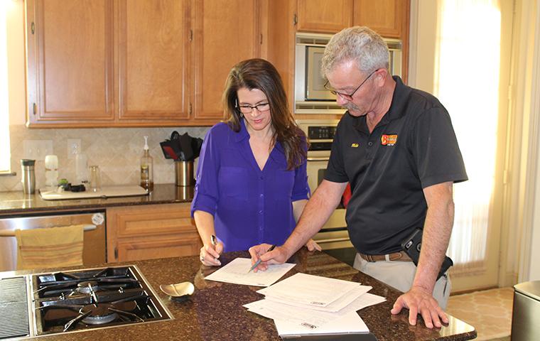 Pest Stop Eliminates Occasional Pest Problems bugspert explaining service to homeowner