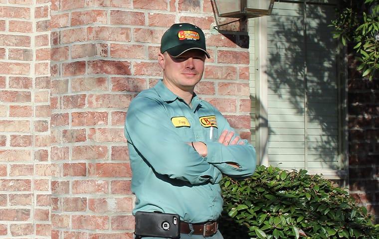 We Are The Port Bolivar, TX Pest Control Experts a technician standing outside a home in port bolivar texas