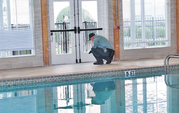 a technician performing a commercial pest inspection in silsbee texas