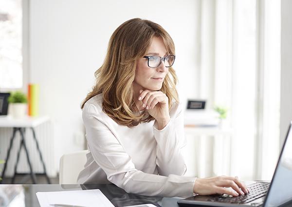 Learn More About The Changes Facebook Is Making woman looking at facebook