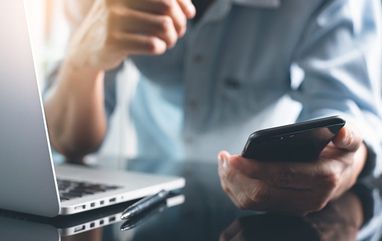 Local SEO Services Help Customers Find Your Business a customer using a laptop and cell phone