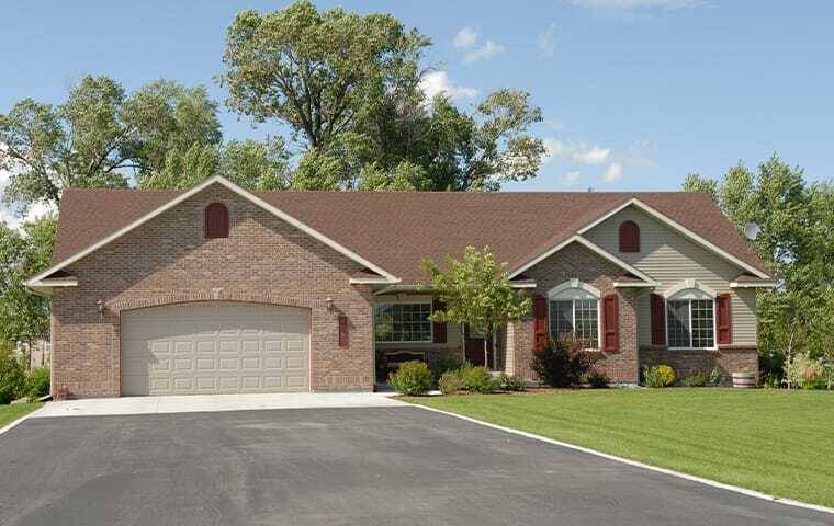 light brick house with landscaping in front