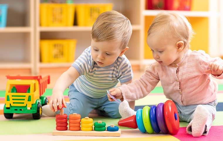two young children playing inside a daycare