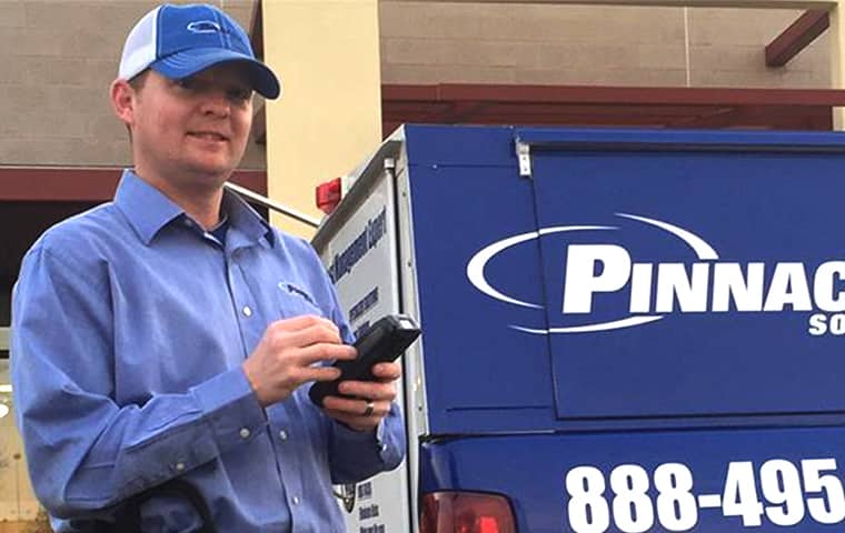 We Offer Reliable Pest Control Services In Kansas pinnacle solutions pest control technician standing in front of a company vehicle in kansas home
