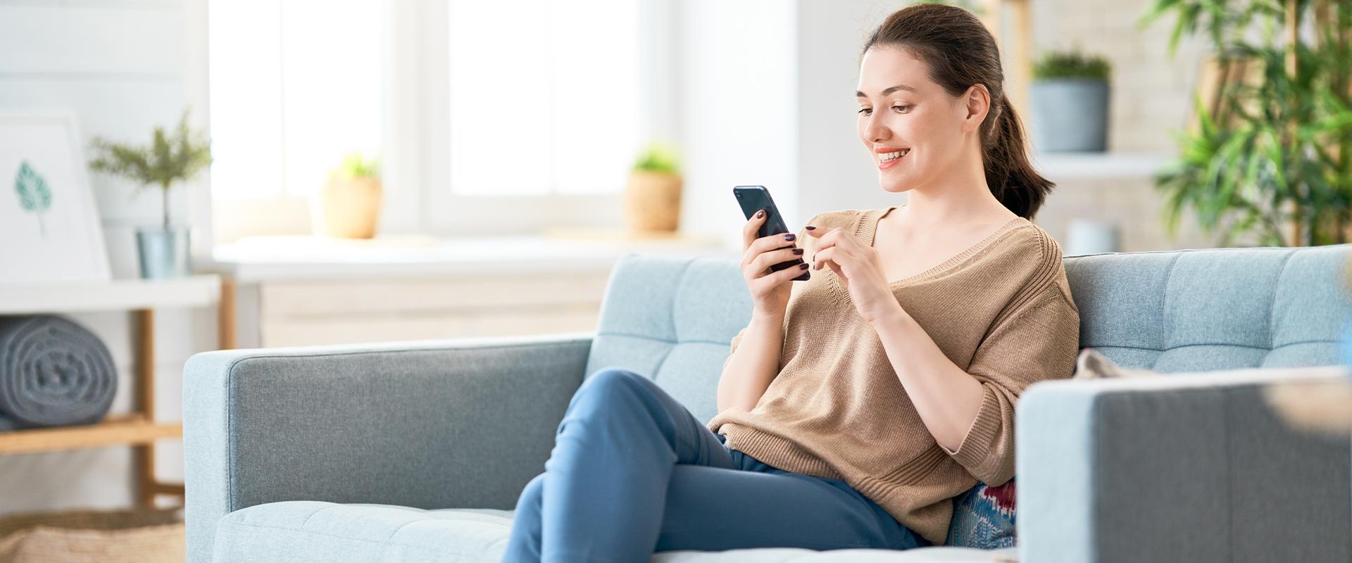 smiling woman on her phone at home