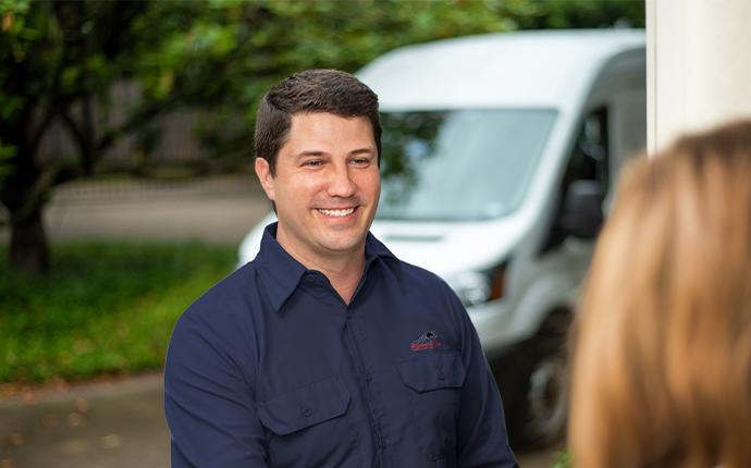 pest control technician greeting customer