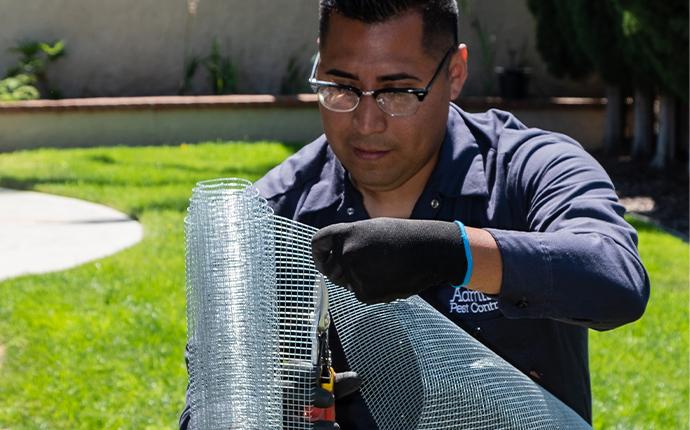 technician holding wire mesh