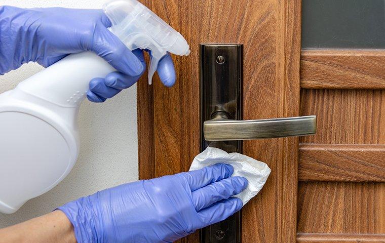 disinfecting a door knob