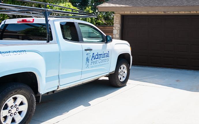 pest control truck parked in front of house