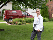 a female technician standing outside of a home in bettendorf iowa