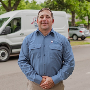 a pest technician standing in front of his service vehicle in modesto california