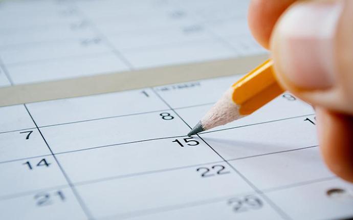 person marking a date on a calendar