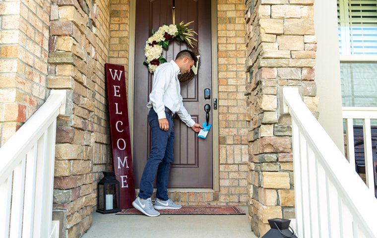 a pest control service technician returning to a home for follow up services in greensboro north carolina