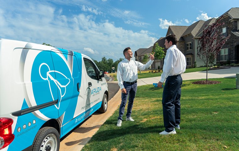 a pest control service technician meeting with a residential homeowner in raleigh north carolina