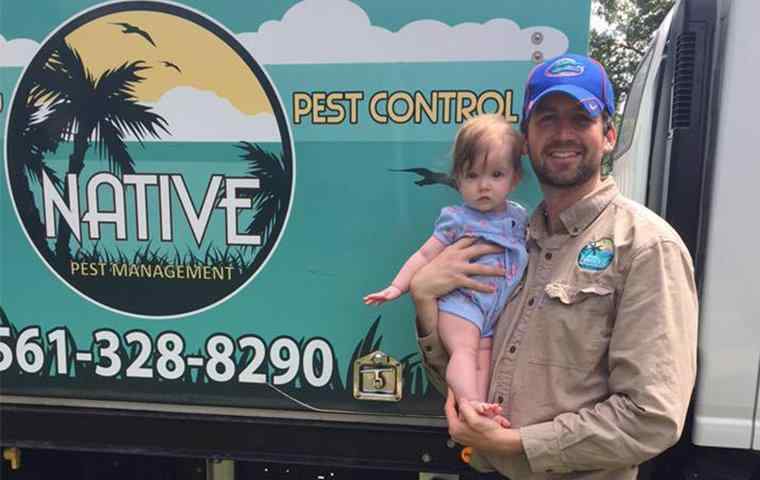 native pest management tech standing in front of company truck