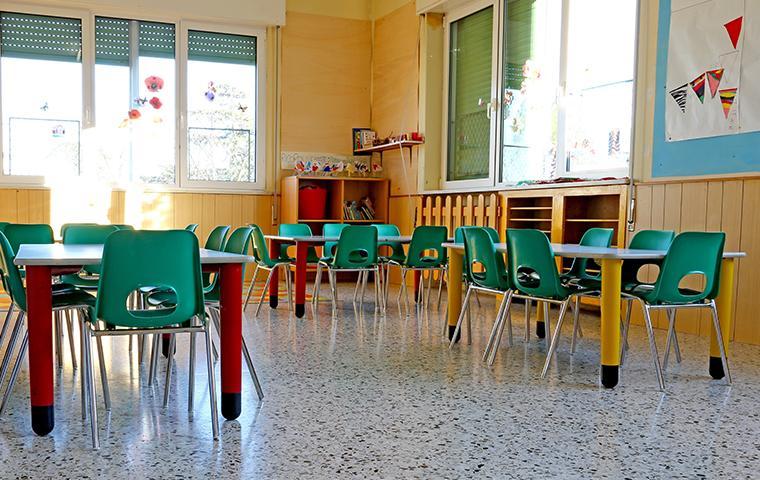 interior of a daycare room without children filled with small tables and chairs