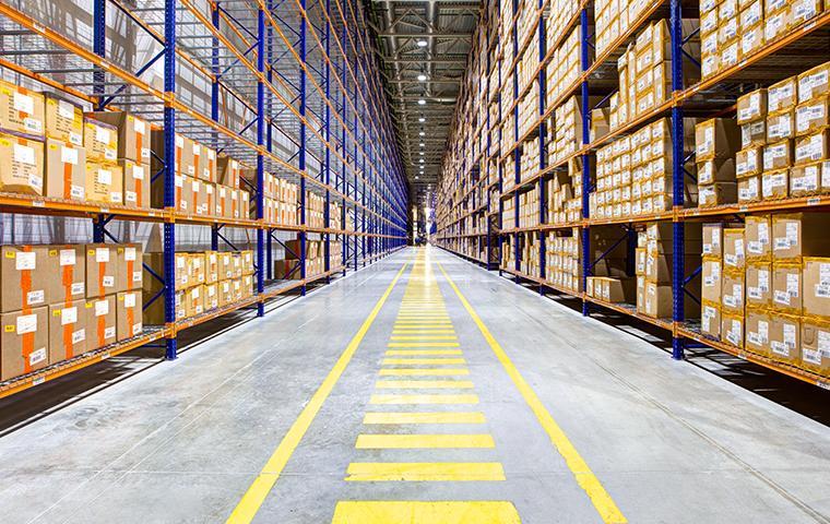 the interior of a large california warehouse looking down a long aisle