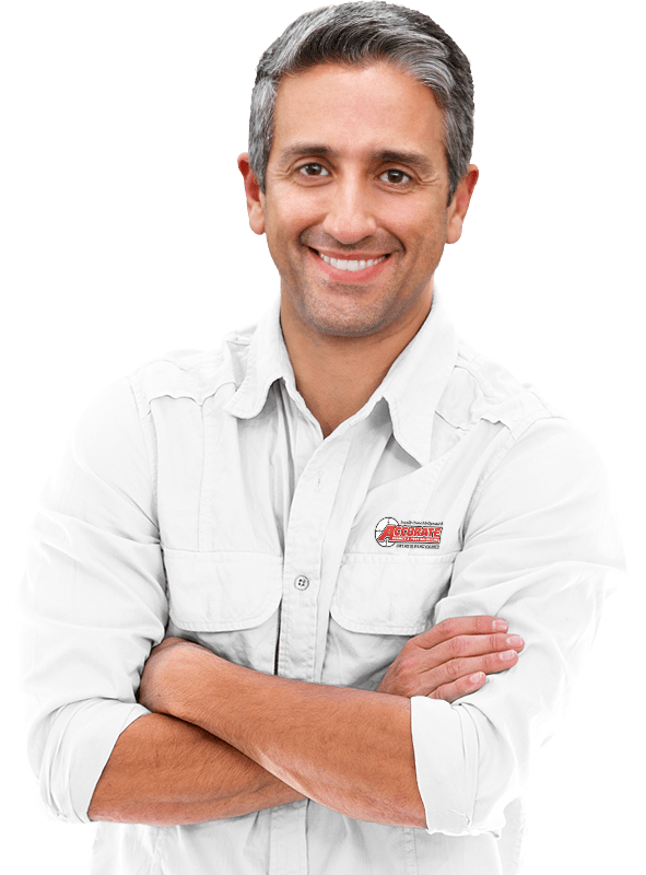 an accurate pest services technician smiling with his arms crossed wearing a white shirt
