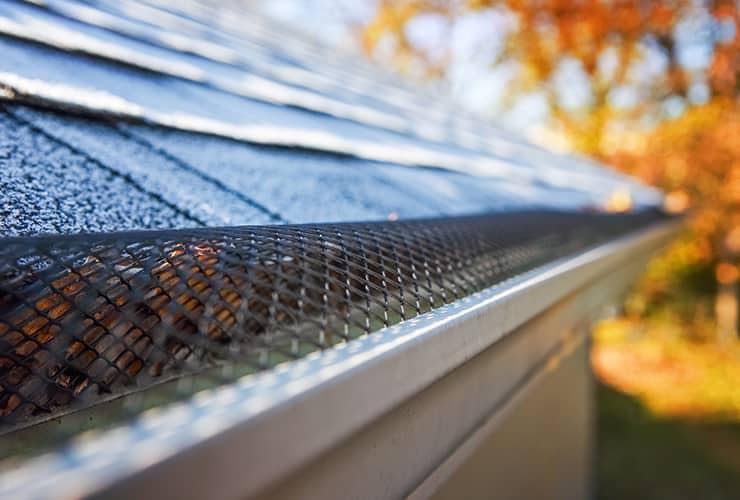 Let Us Help You Protect Your Home This Year residential home with gutter leaf blocker installed