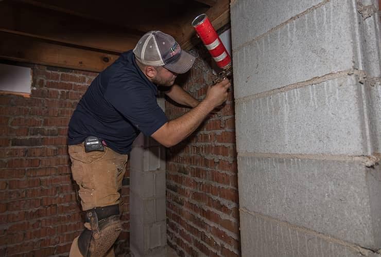 Why You Should Protect Your Home From Moisture technician performing moisture control in a basement
