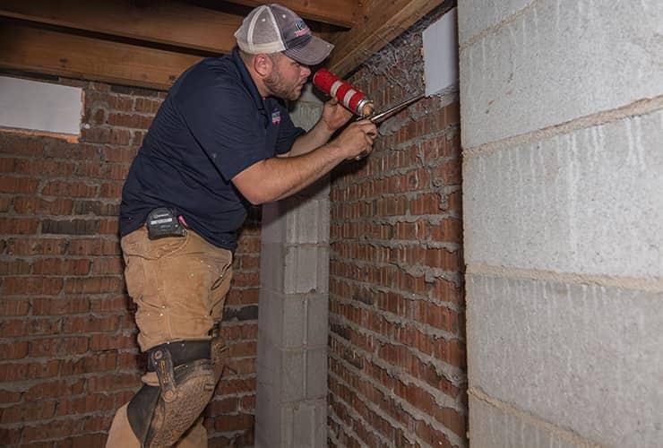Moisture Can Be Just As Big A Pest pest control technician moisture proofing a home