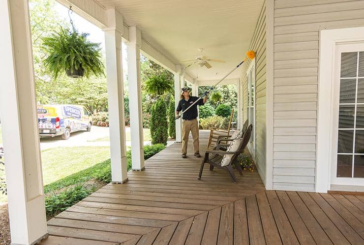 Spencer Takes Care Of Clients With A Free Pest Control Service greenville pest control technician removing spider webs