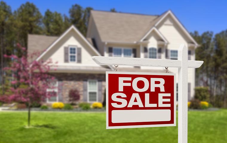 house with for sale sign in front