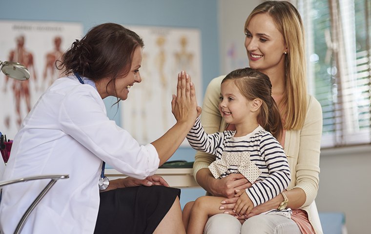 friendly doctor with parent and child