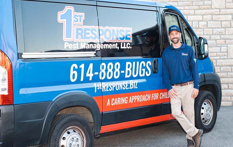 a pest expert treating outside of a home