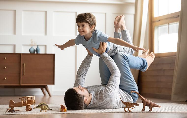 a father and son playing in living room