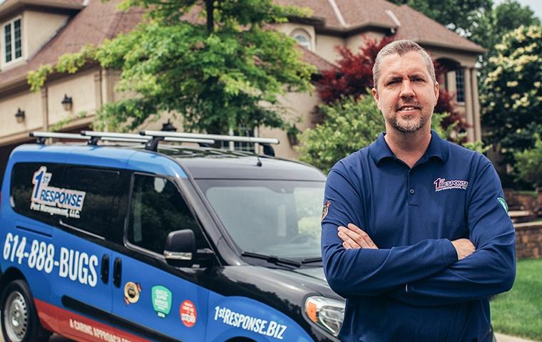 a pest expert treating outside of a home