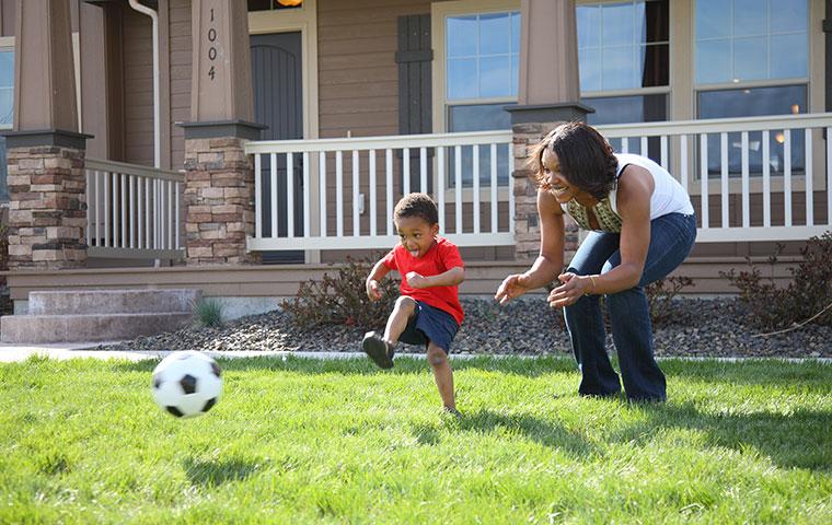 mom and son playing soccer