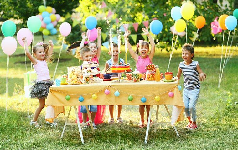 four children outside at a birthday party