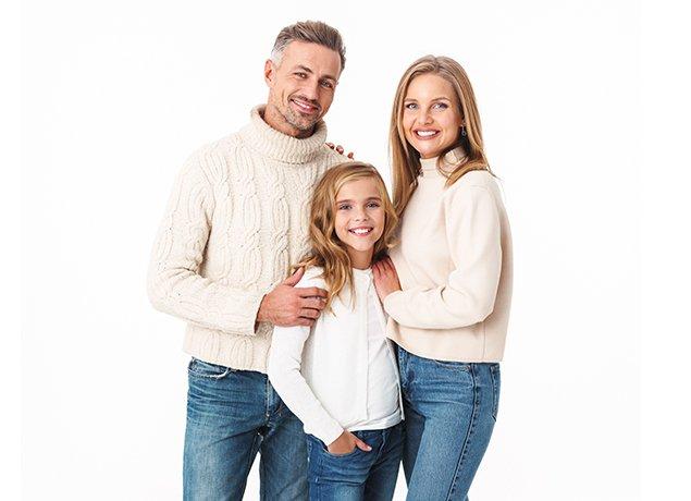 a smiling family of three