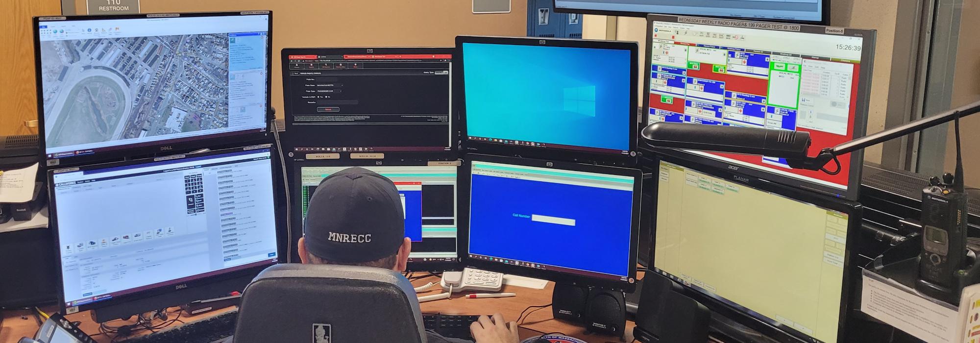 Person working with multiple computer monitors