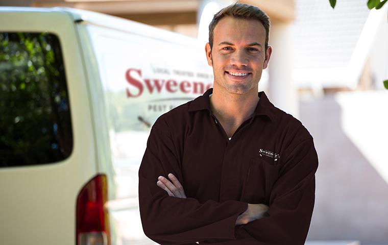 a tech standing in front of a sweeneys pest elimination truck