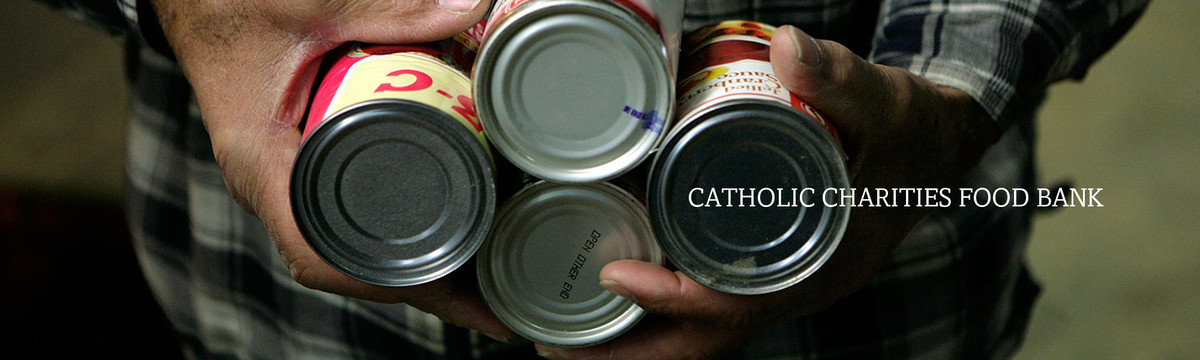 A man carries cans of food in his hands. Our network of food banks in Aroostook County in northern Maine help those in need.