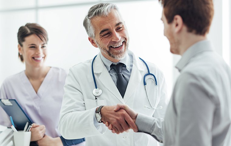 doctor shaking hands with patient