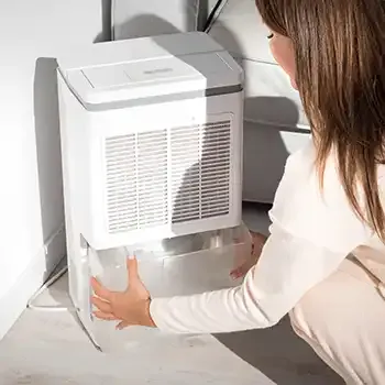 woman installing a dehumidifier