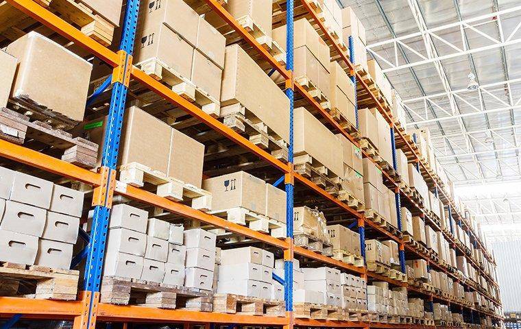 warehouse with shelves stacked high with boxes