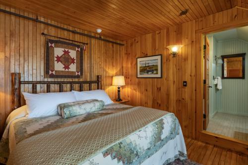 A bed in a wood paneled room