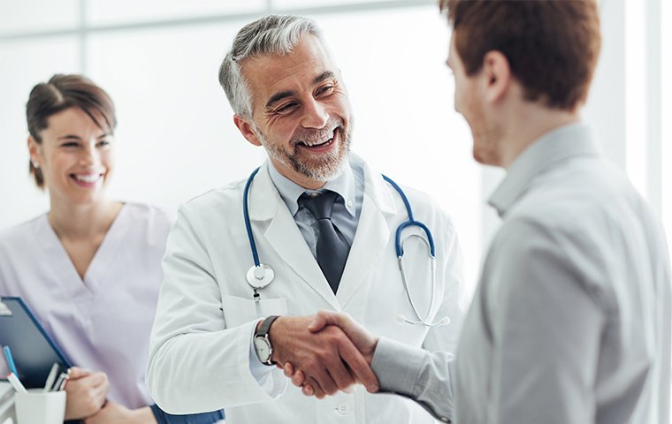 a doctor shaking hands with a patient