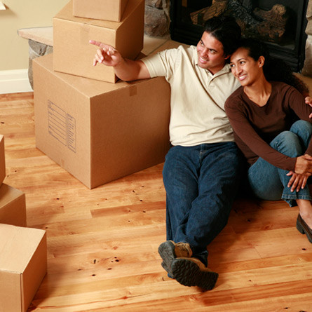 couple sitting among moving boxes