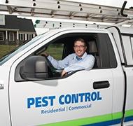 technician in white truck that says pest control residential commercial
