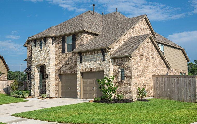 Protect Your Lakeway Home From Rodents & Bed Bugs street view of a large brick house in lakeway texas
